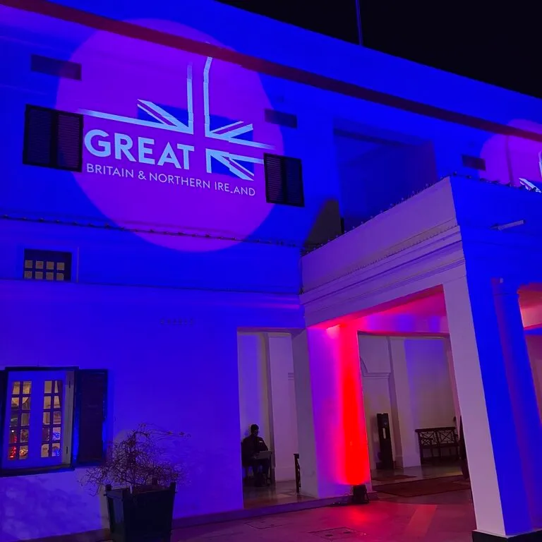 British High Commission reception venue lit in blue and red